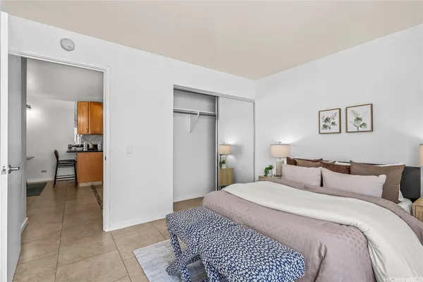 a bedroom with a bed and a view of bathroom