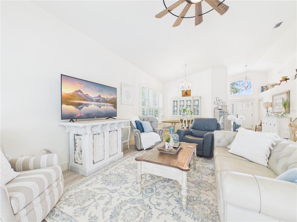 426 Long Cove Road Ormond Beach, FL 32174 - Photo 8 of 73 a living room with furniture a couch and a flat screen tv