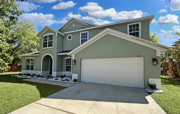 a front view of a house with yard