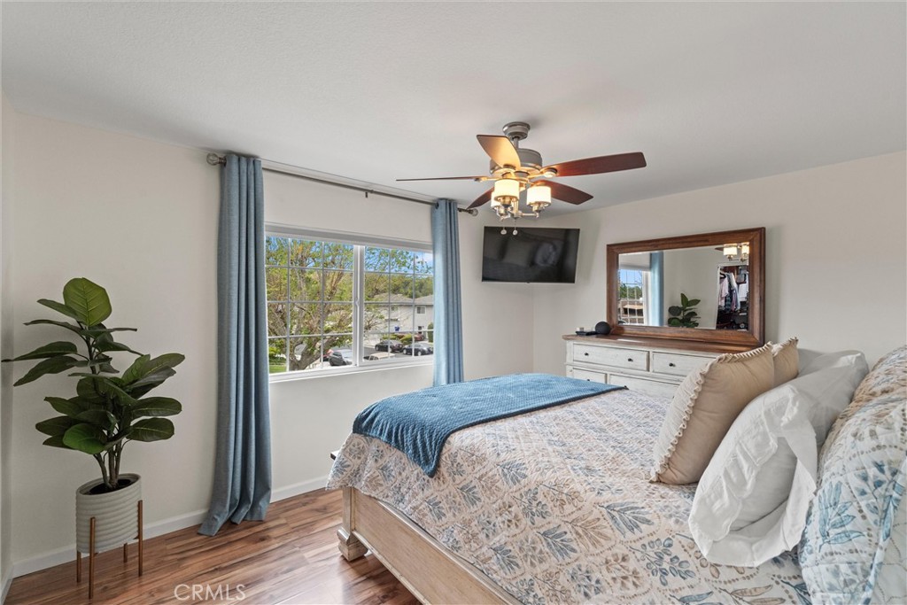 20800 Plum Canyon Road Saugus, CA 91350 - Photo 16 of 26 a bedroom with a large bed and a chandelier