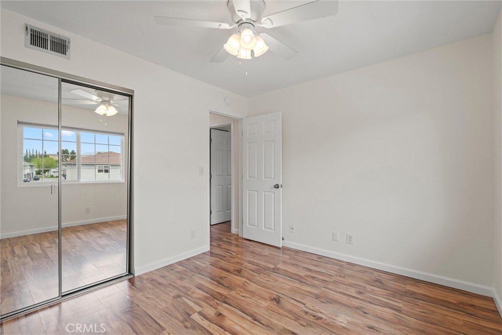 20800 Plum Canyon Road Saugus, CA 91350 - Photo 22 of 26 a view of a kitchen with wooden floor and a ceiling fan