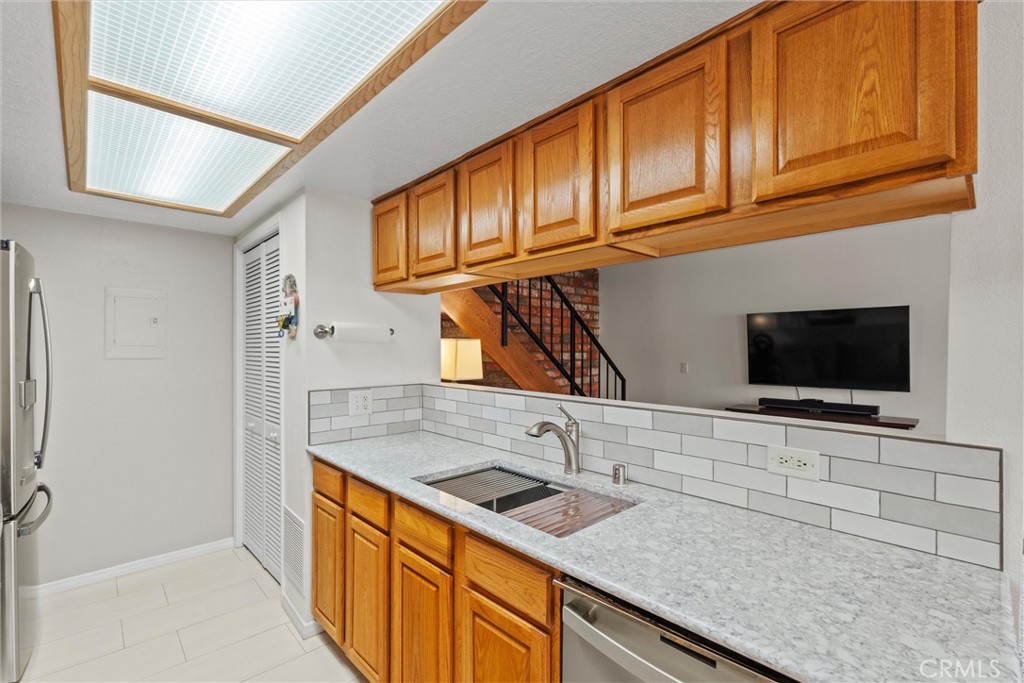 20800 Plum Canyon Road Saugus, CA 91350 - Photo 10 of 26 a kitchen with stainless steel appliances granite countertop a sink a stove and a microwave oven