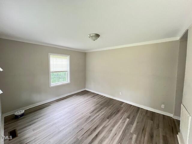 7710 Leasburg Road Roxboro, NC 27574 - Photo 15 of 24 an empty room with wooden floor and windows