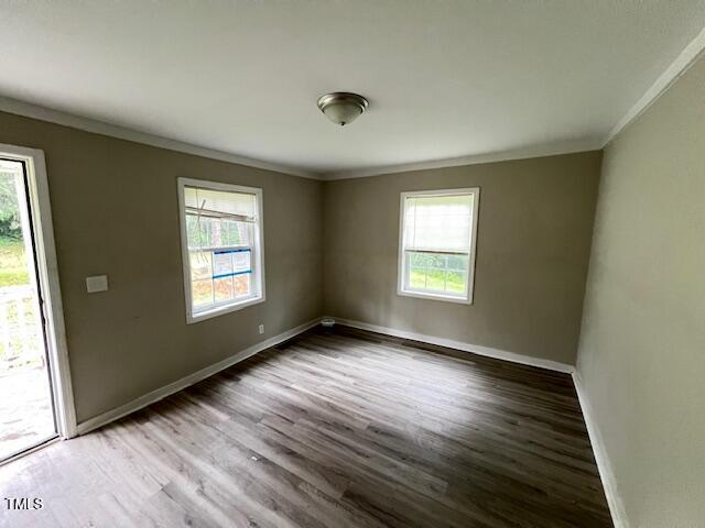 7710 Leasburg Road Roxboro, NC 27574 - Photo 16 of 24 an empty room with wooden floor and windows