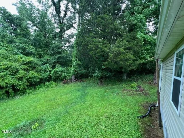 a backyard of a house with lots of green space