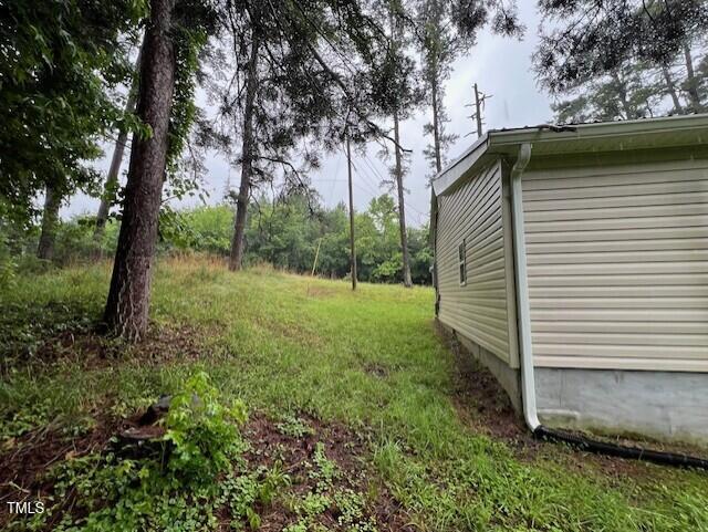 7710 Leasburg Road Roxboro, NC 27574 - Photo 8 of 24 a backyard of a house with lots of green space