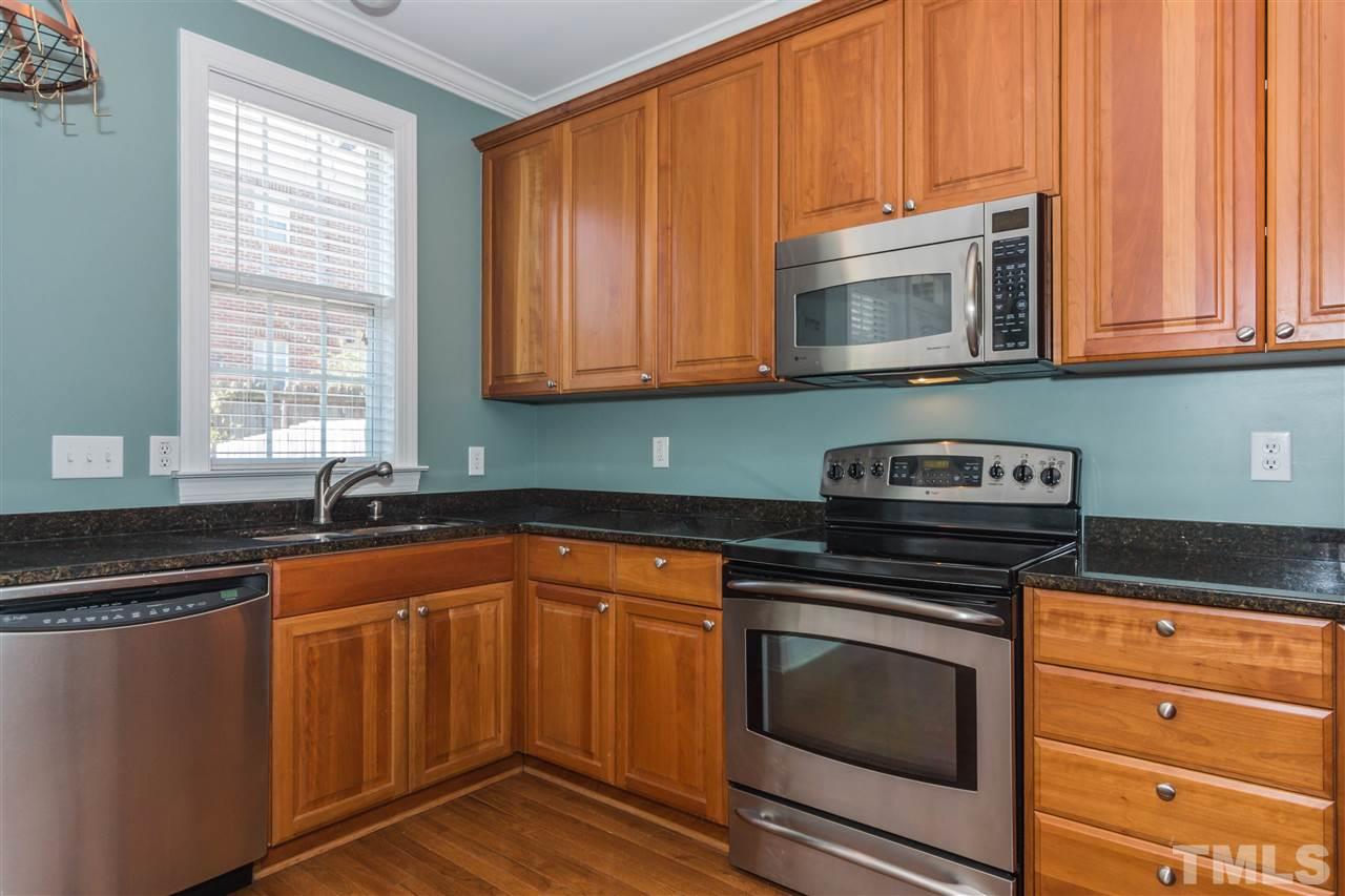 610 Highpark Lane Raleigh, NC 27608 - Photo 11 of 25 a kitchen with granite countertop cabinets stainless steel appliances and a sink