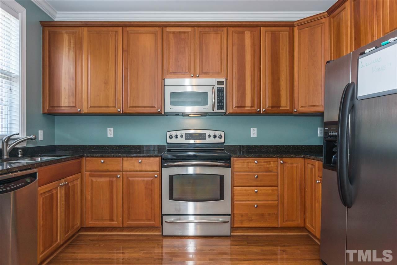 610 Highpark Lane Raleigh, NC 27608 - Photo 12 of 25 a kitchen with granite countertop stainless steel appliances and refrigerator