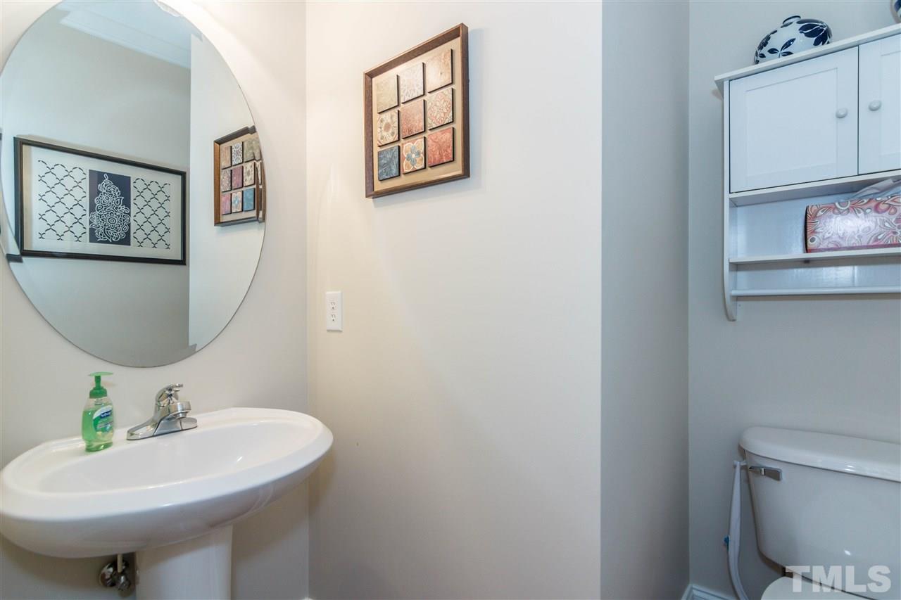 610 Highpark Lane Raleigh, NC 27608 - Photo 14 of 25 a bathroom with a sink a mirror and toilet