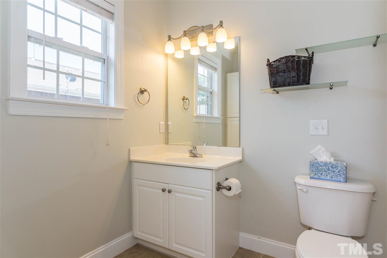 610 Highpark Lane Raleigh, NC 27608 - Photo 17 of 25 a bathroom with a toilet a sink and mirror