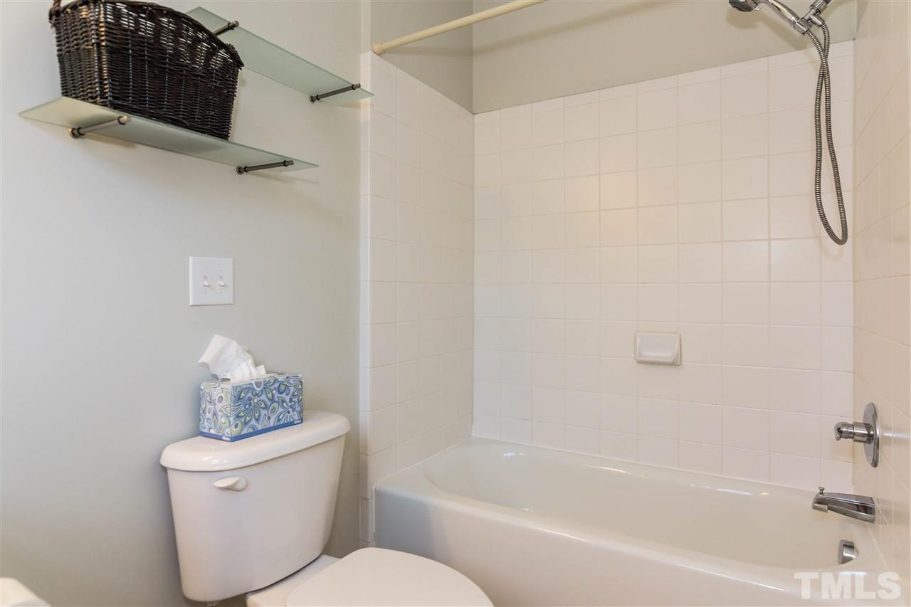 610 Highpark Lane Raleigh, NC 27608 - Photo 18 of 25 a white toilet sitting next to a bath tub