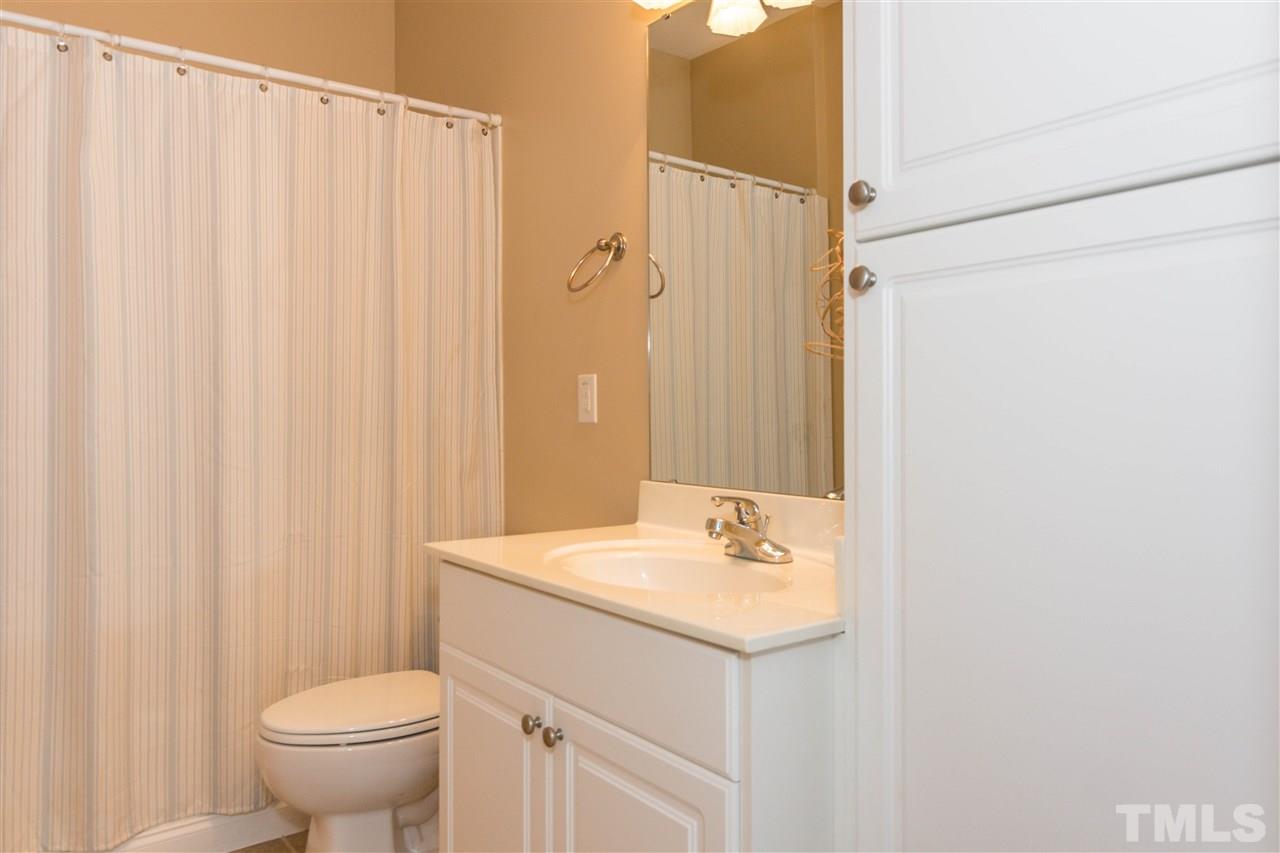 610 Highpark Lane Raleigh, NC 27608 - Photo 21 of 25 a bathroom with a sink a toilet and shower curtain