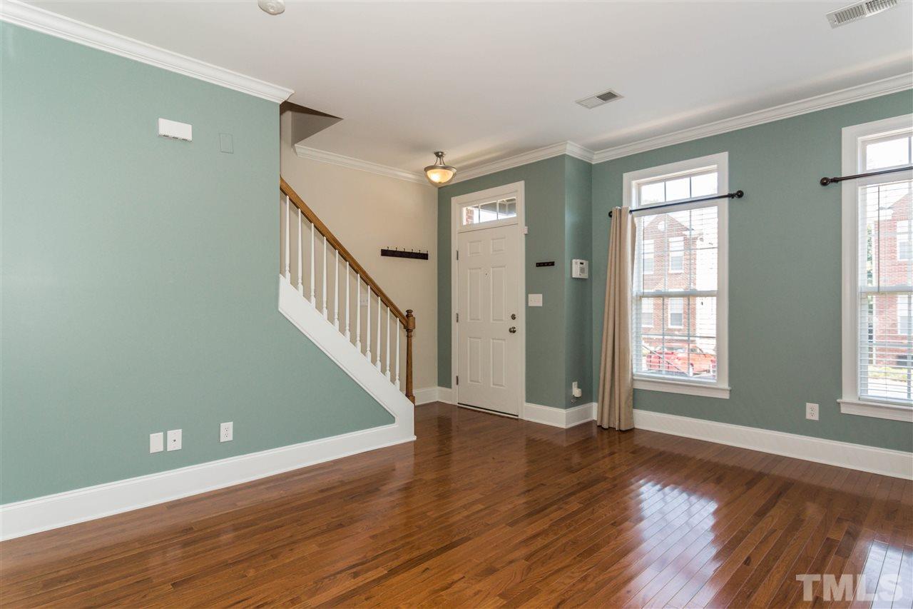 610 Highpark Lane Raleigh, NC 27608 - Photo 6 of 25 a view of an empty room with wooden floor and a window