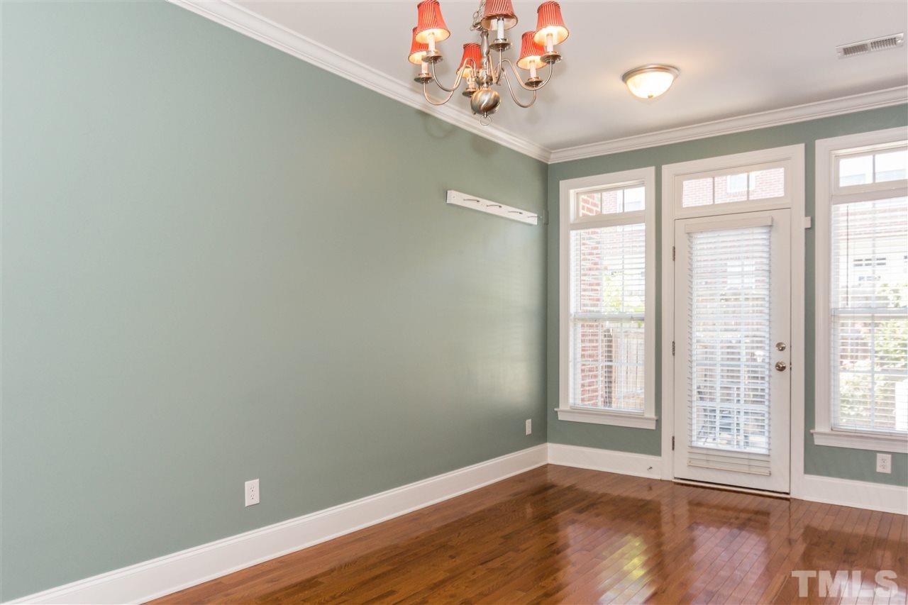 610 Highpark Lane Raleigh, NC 27608 - Photo 8 of 25 an empty room with wooden floor and windows