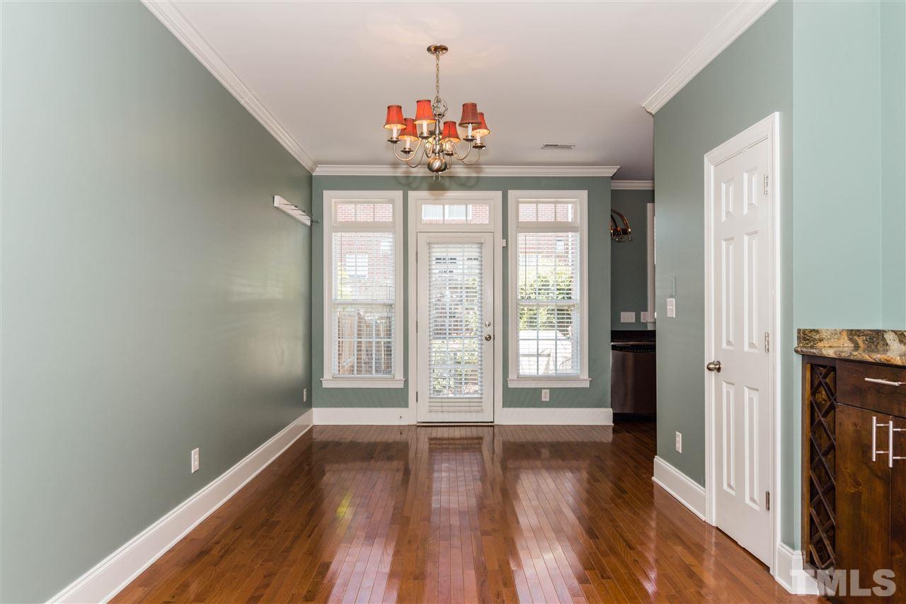 610 Highpark Lane Raleigh, NC 27608 - Photo 9 of 25 a view of an empty room with wooden floor and a window