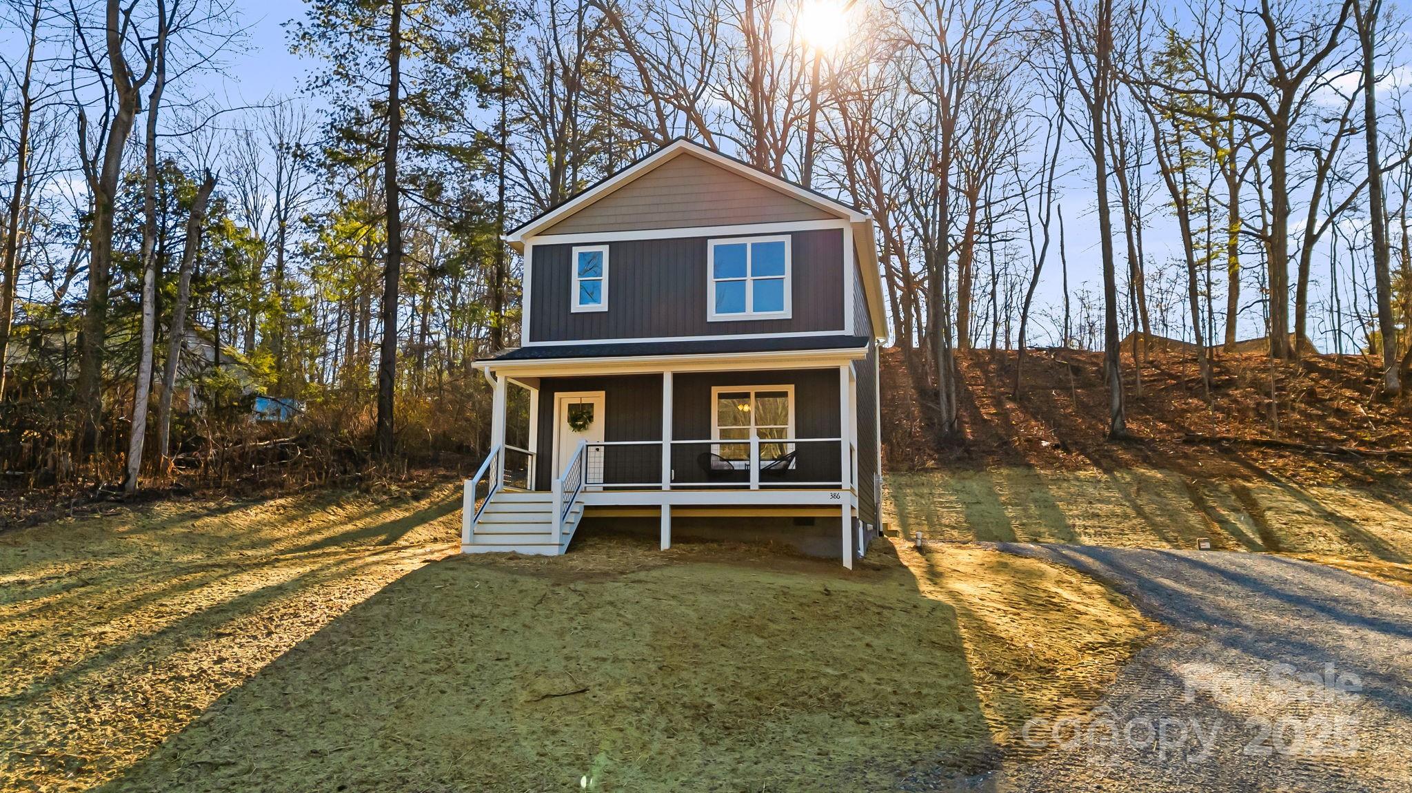 386 Holtzclaw Street Canton, NC 28716 - Photo 1 of 43 a front view of a house with a yard
