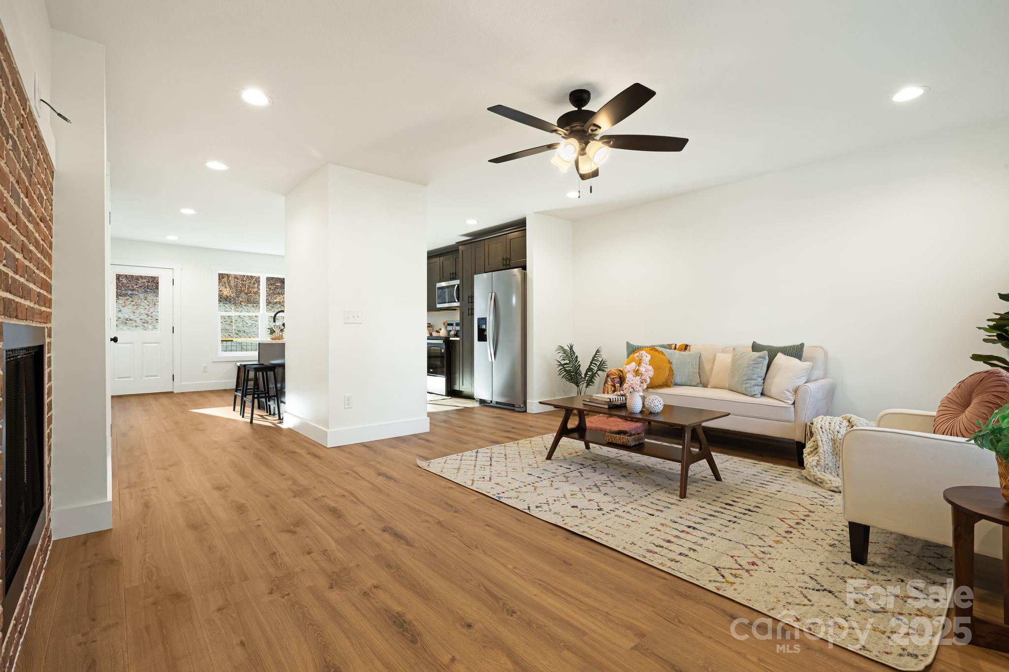 386 Holtzclaw Street Canton, NC 28716 - Photo 12 of 43 a living room with furniture and a wooden floor