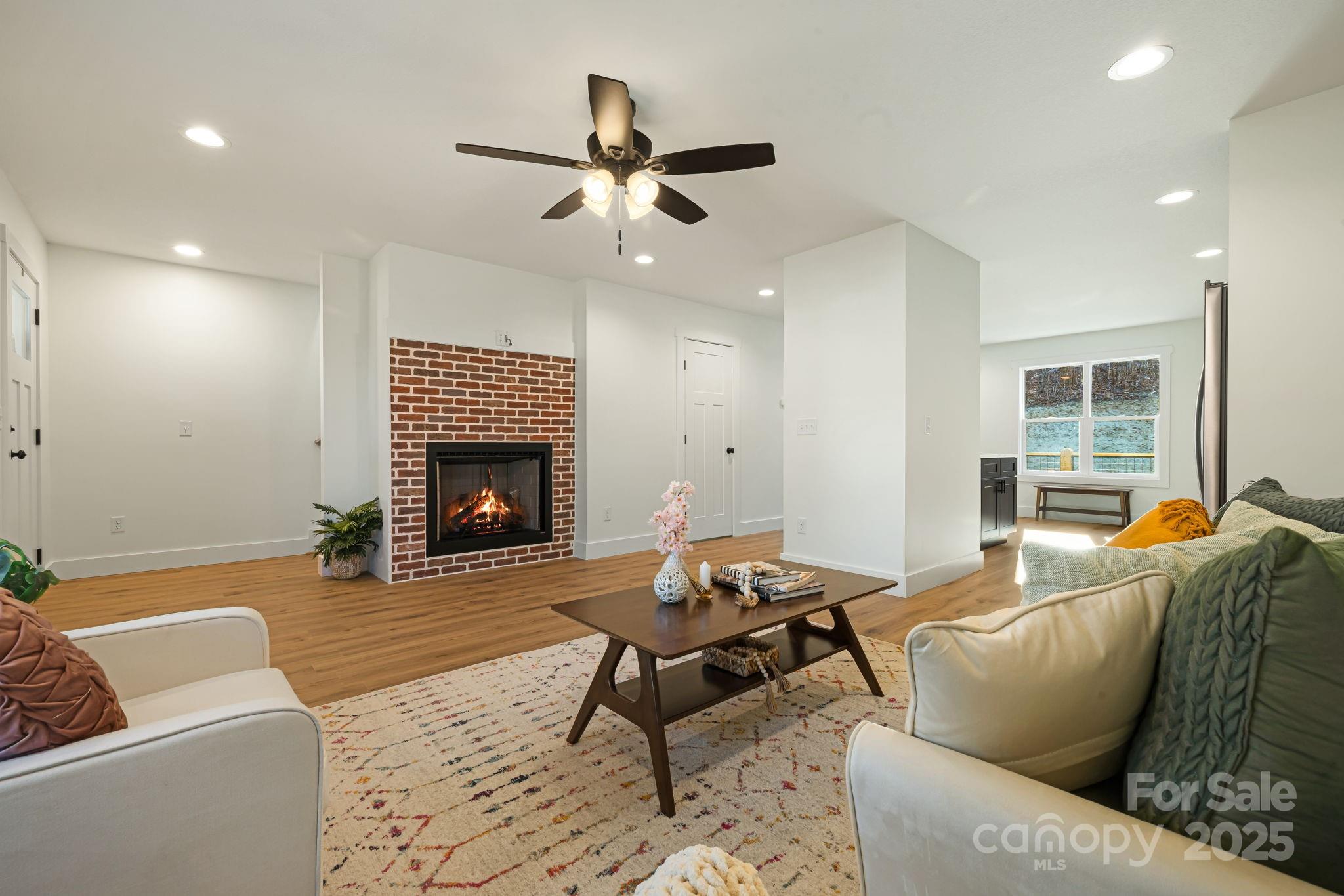 386 Holtzclaw Street Canton, NC 28716 - Photo 13 of 43 a living room with furniture and a fireplace