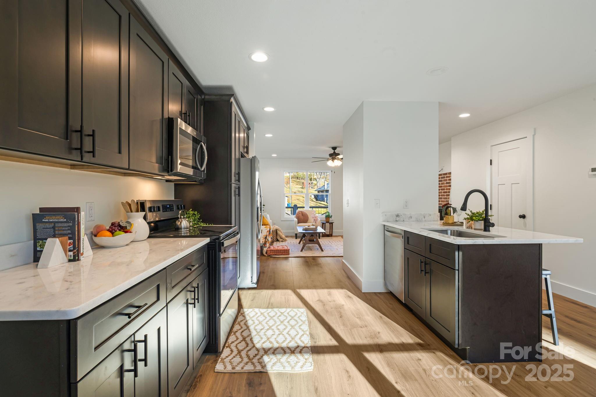 386 Holtzclaw Street Canton, NC 28716 - Photo 17 of 43 a kitchen with granite countertop stainless steel appliances lots of counter top space