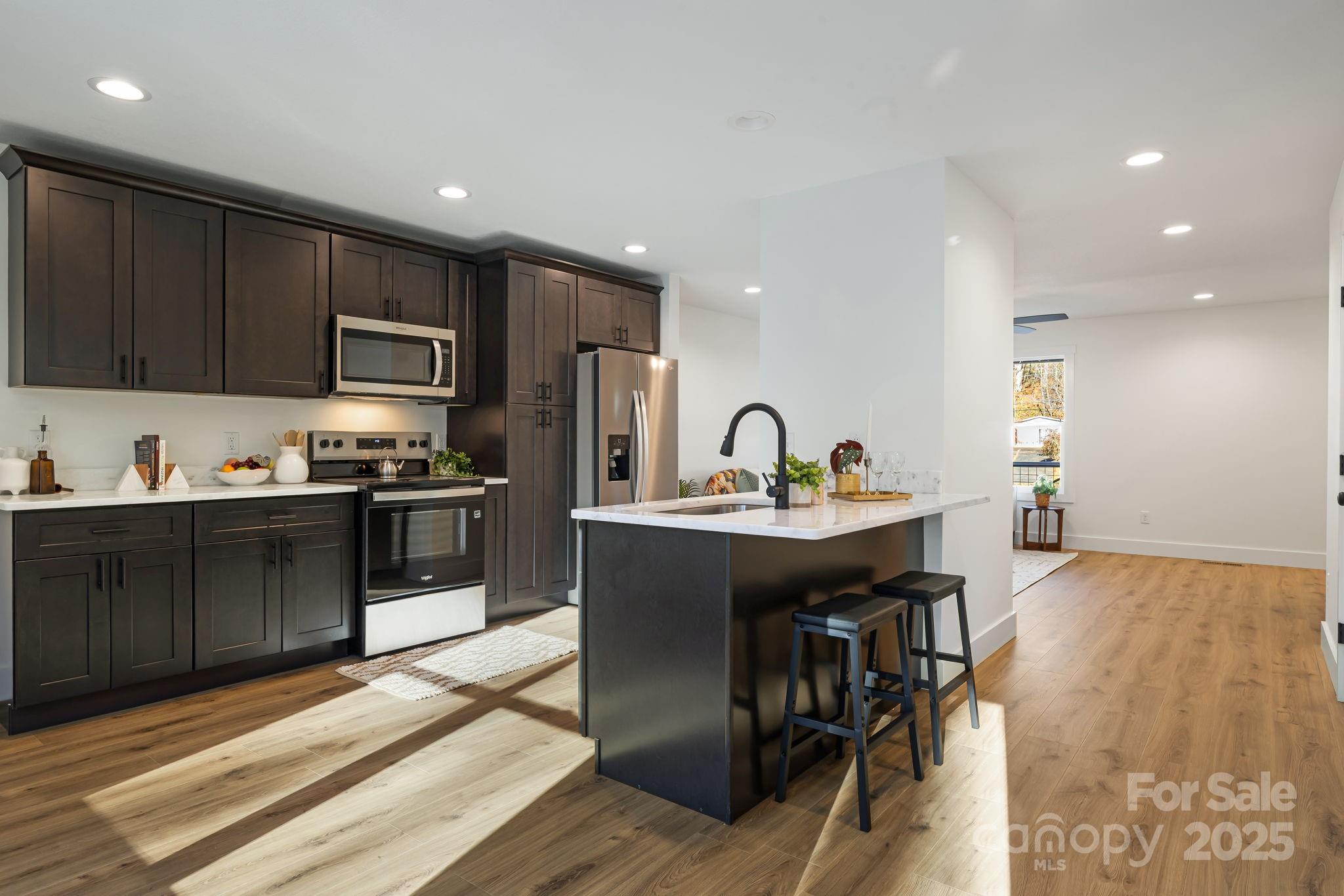 386 Holtzclaw Street Canton, NC 28716 - Photo 18 of 43 a kitchen with a sink stainless steel appliances and cabinets