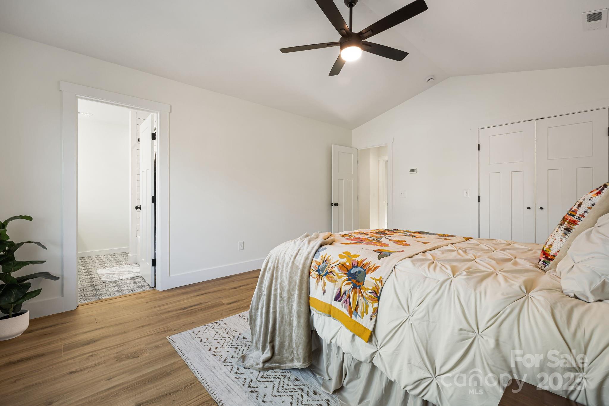 386 Holtzclaw Street Canton, NC 28716 - Photo 29 of 43 a bedroom with a bed and wooden floor