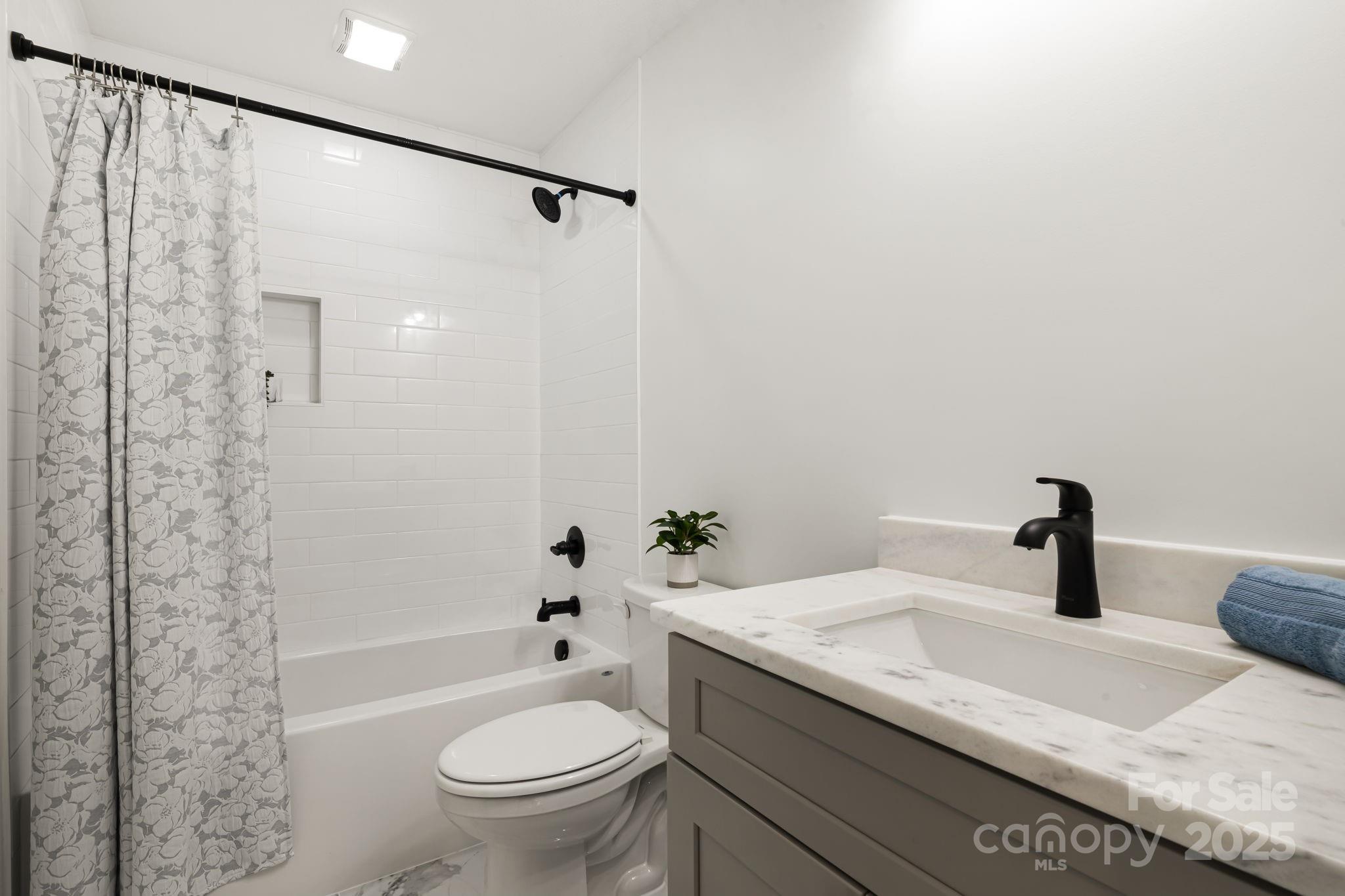 386 Holtzclaw Street Canton, NC 28716 - Photo 36 of 43 a bathroom with a granite countertop sink toilet and shower