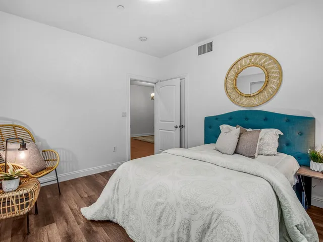 a bedroom with a bed and a chandelier