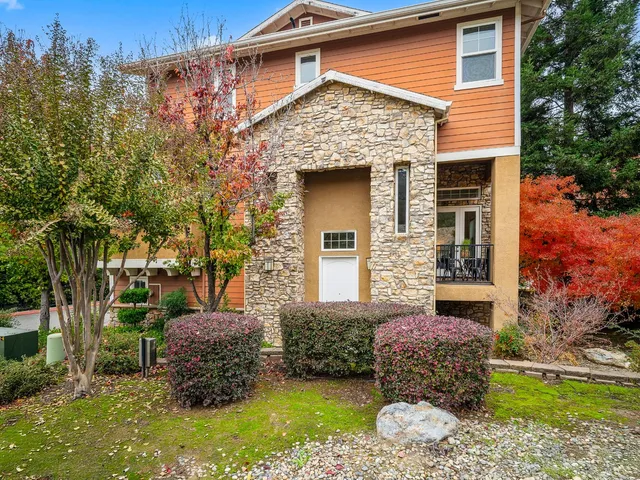 a front view of a house with garden