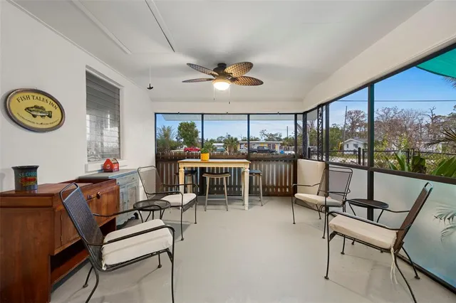 a dining room with furniture and a large window