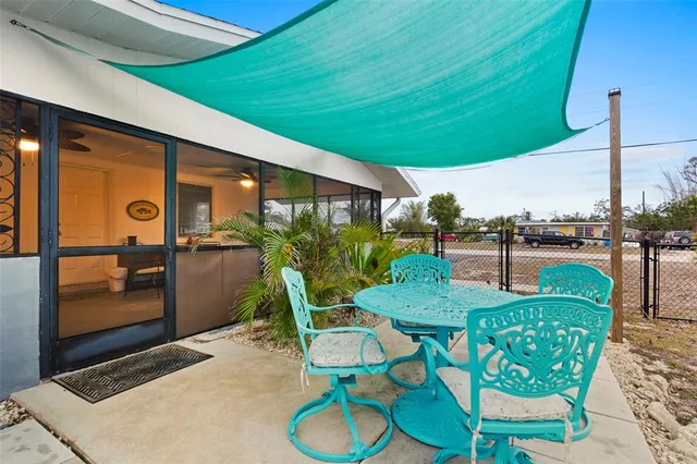 a view of a patio with table and chairs potted plants with wooden floor