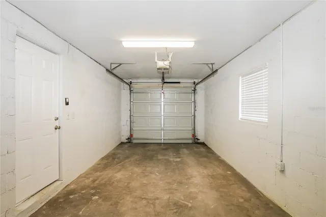 an empty room with closet and windows