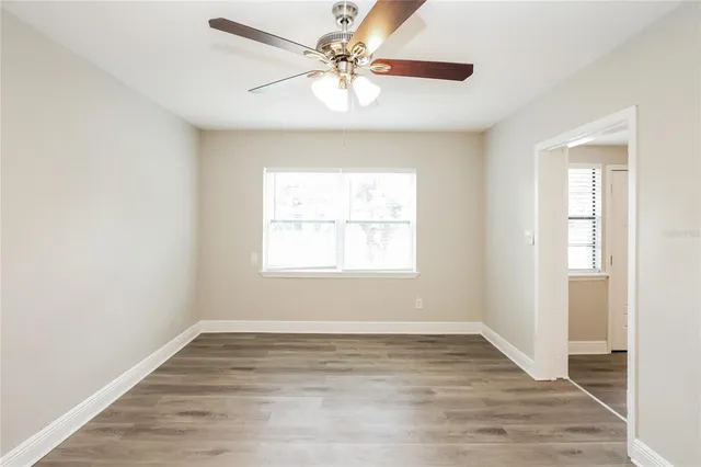 wooden floor in an empty room with a window