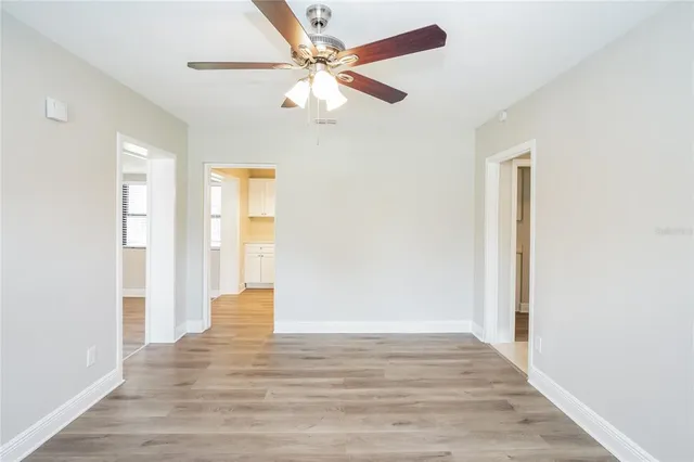 a view of an empty room with wooden floor