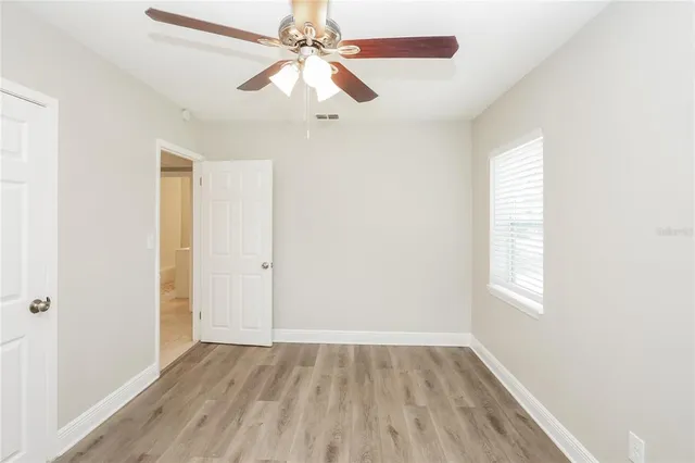 wooden floor in an empty room with a window