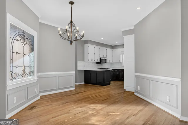 a kitchen with stainless steel appliances a sink a stove a refrigerator and cabinets