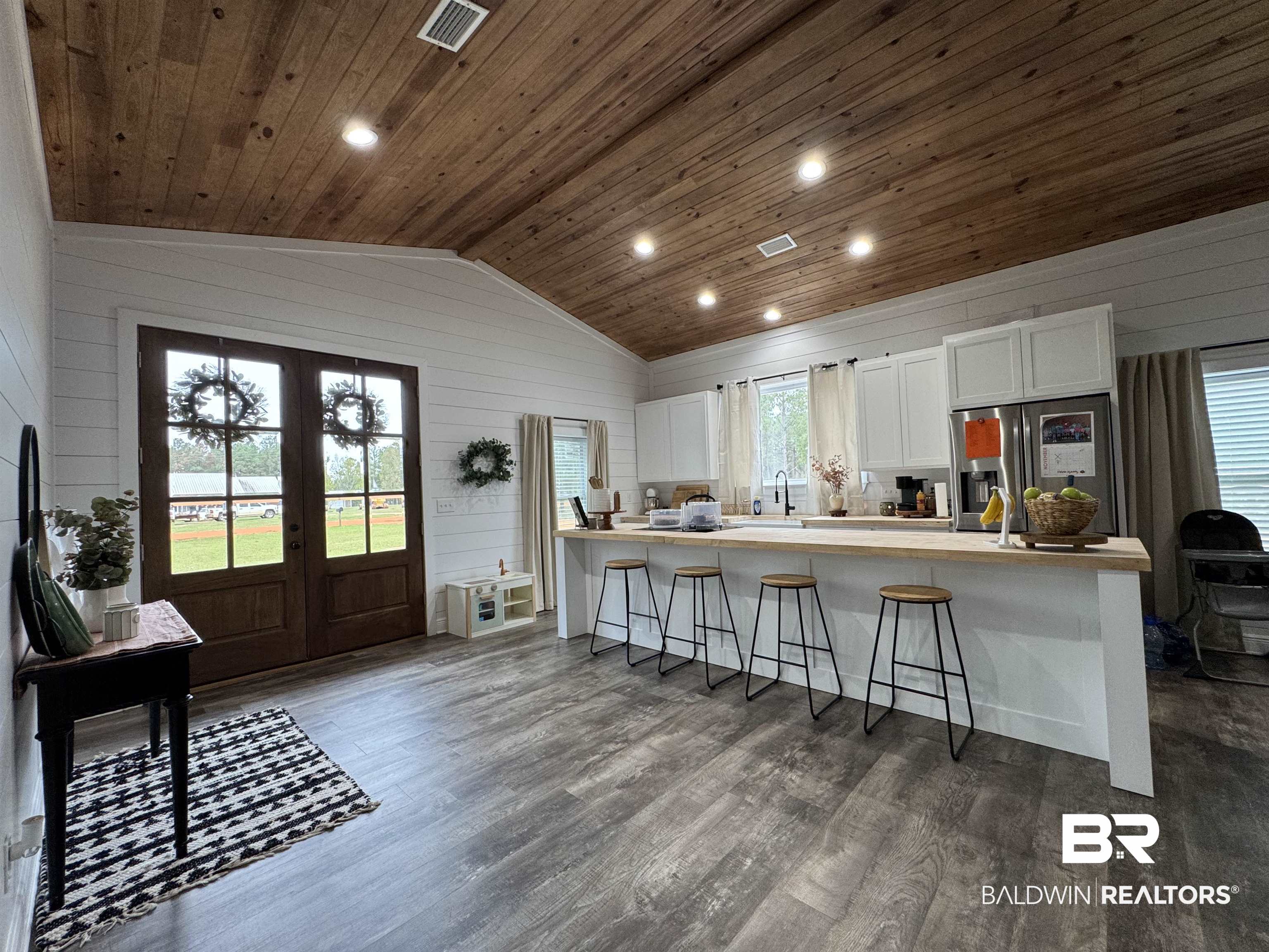 370 Dianne Road Frisco City, AL 36445 - Photo 12 of 41 Kitchen with french doors, stainless steel fridge, dark hardwood / wood-style floors, wood ceiling, and white cabinets