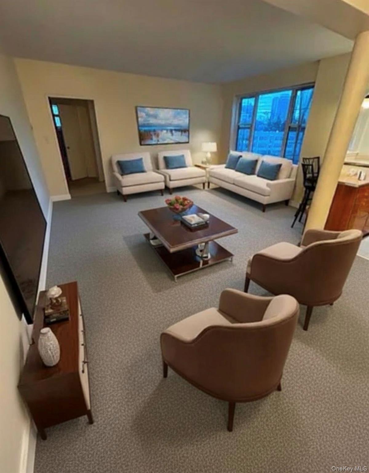 a living room with furniture and a flat screen tv