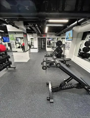 a room with gym equipment and a large window