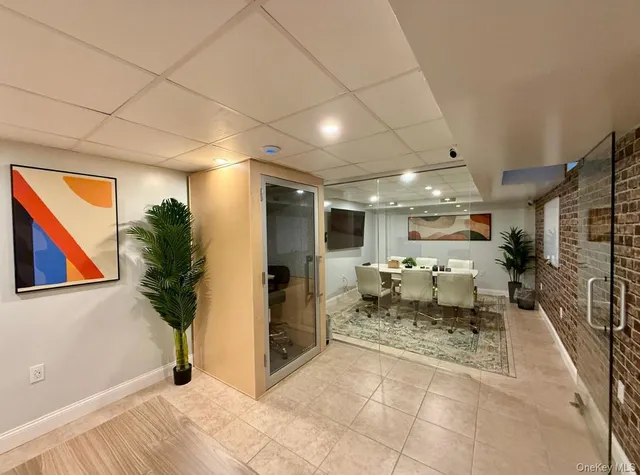 a white house with sink and a mirror