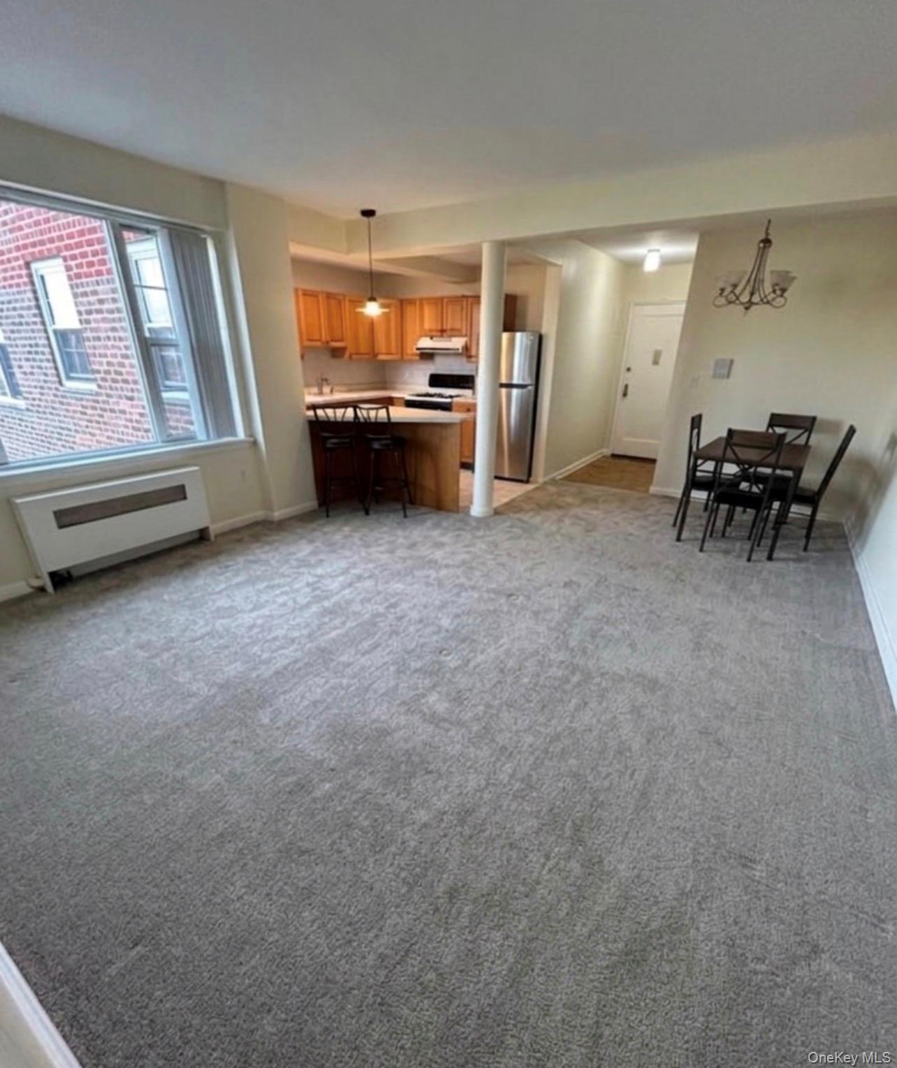 230 Pelham Road, Unit 6F New Rochelle, NY 10805 - Photo 2 of 29 a living room with furniture and a large window