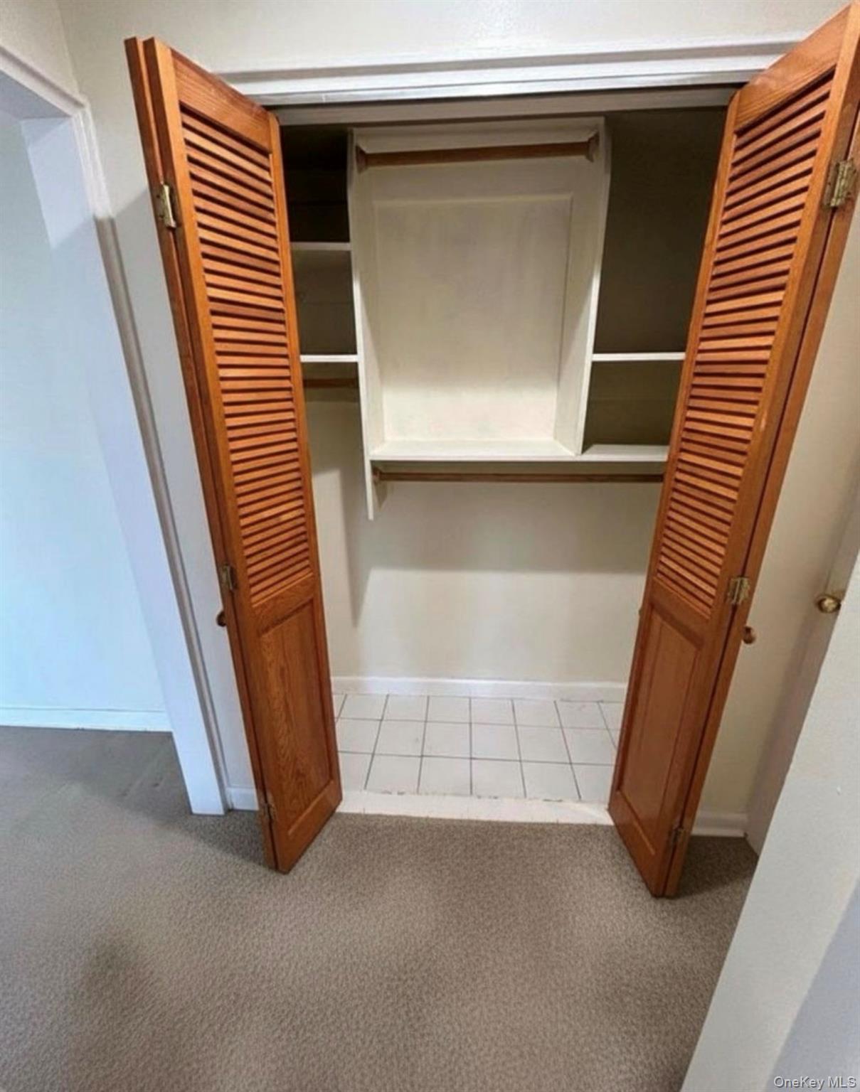 230 Pelham Road, Unit 6F New Rochelle, NY 10805 - Photo 6 of 29 a view of an empty room with wooden floor and cabinet