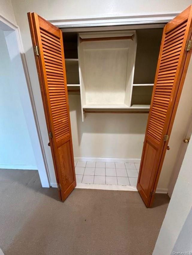 230 Pelham Road, Unit 6F New Rochelle, NY 10805 - Photo 7 of 28 a view of an empty room with wooden floor and a window