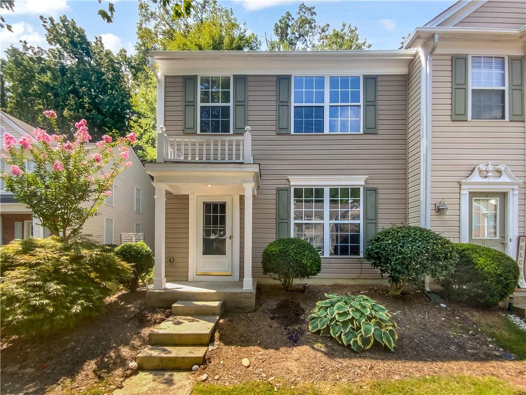 9155 Nesbit Ferry Road, Unit 82 Alpharetta, GA 30022 - Photo 1 of 1 a front view of a house with garden