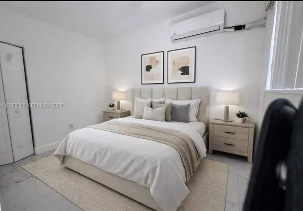 a bedroom with a bed and a window