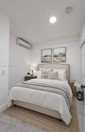 a bedroom with a bed and a night stand