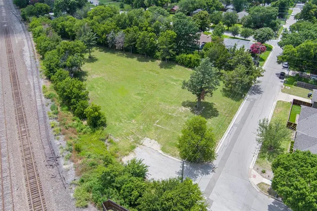 an aerial view of residential house with outdoor space and trees all around