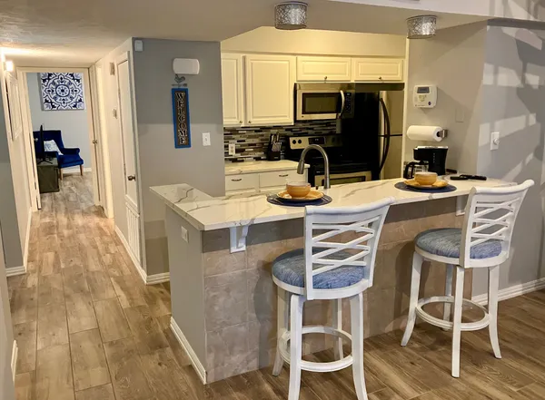 a dining room with furniture and a flat screen tv