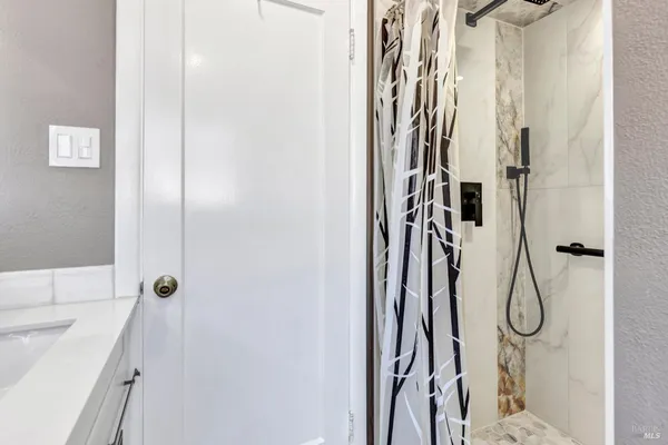 a bathroom with a bathtub and shower