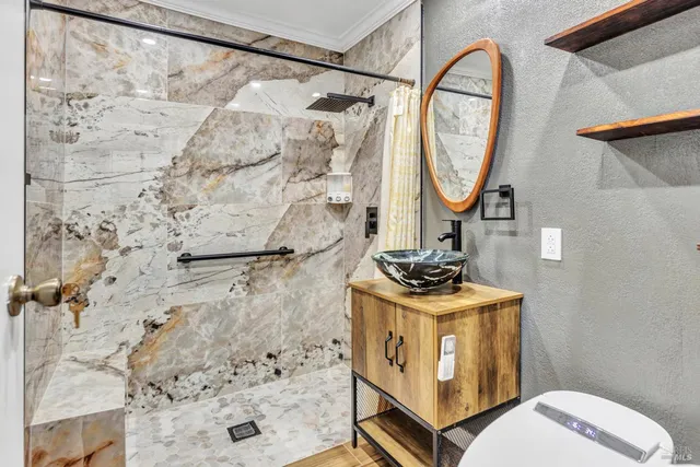 a bathroom with a sink toilet and shower