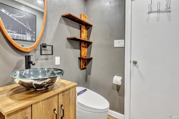 a bathroom with a toilet a sink and mirror